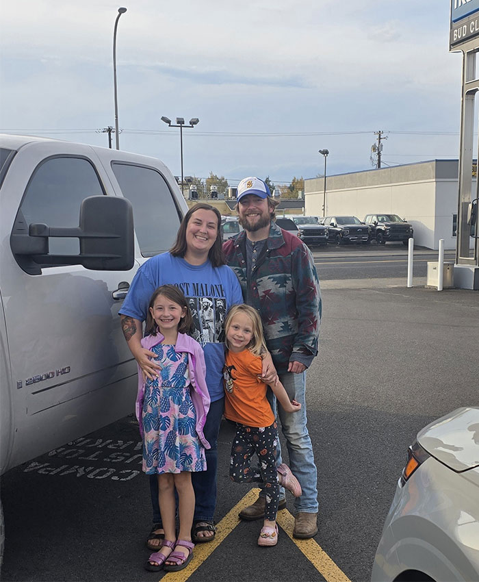 Happy family with their vehicle at Bud Clary